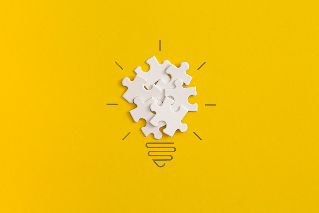 żarówka z puzzli na żółtym tle