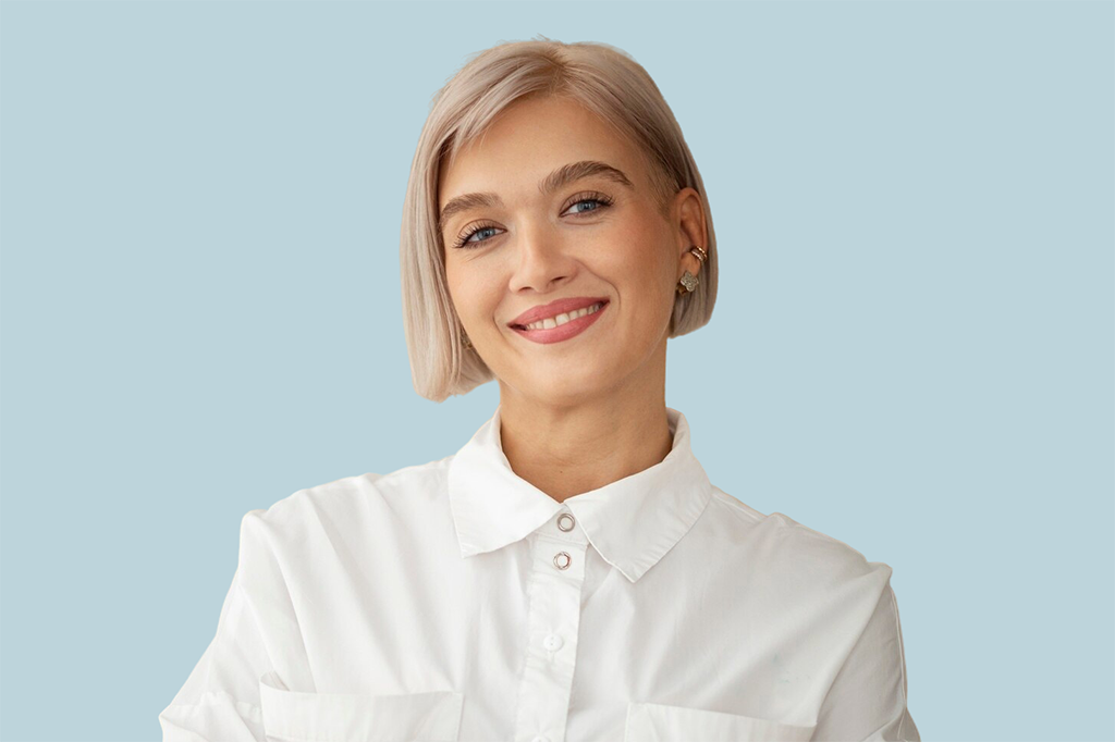 uśmiechnięta blondynka w białej koszuli